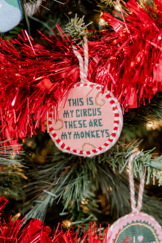 Decorative Christmas ornament with text 'This is my circus, these are my monkeys' on a tree.
