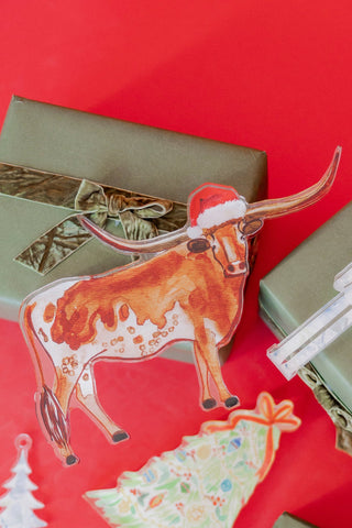 Gift boxes with decorative stickers of a cow and Christmas tree on a red background