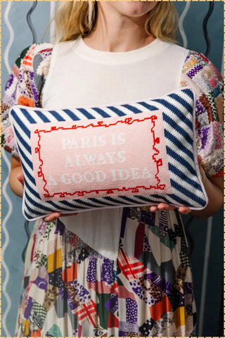 Model holding a needlepoint pillow that says "Paris is always a good idea" | Speakeasy Needle Works | Dallas, TX